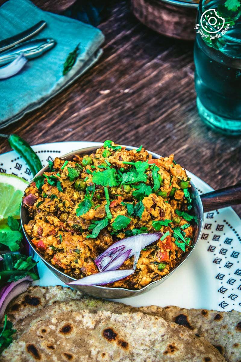 a plate of food with a bowl of punjabi paneer bhurji dry on it