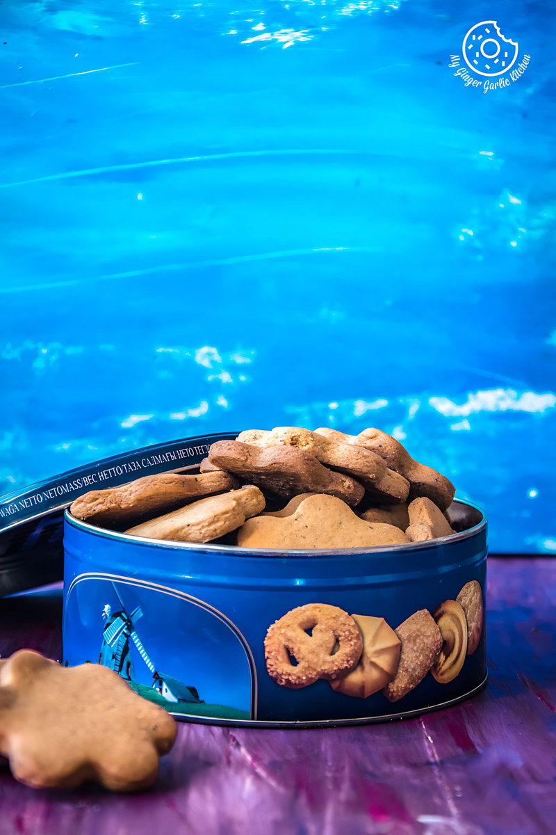 a tin of tta biscuits with a blue background