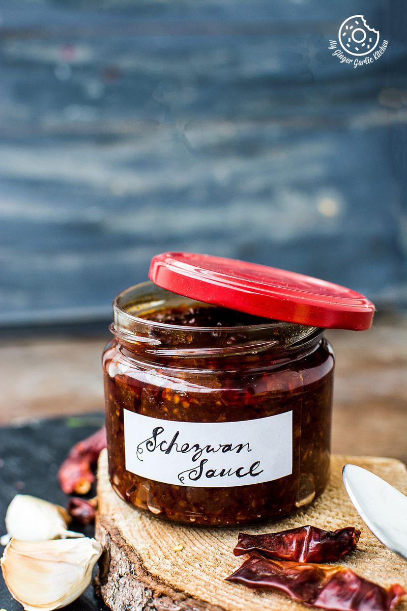 a jar of schezwan sauce or chili sauce on a wooden table
