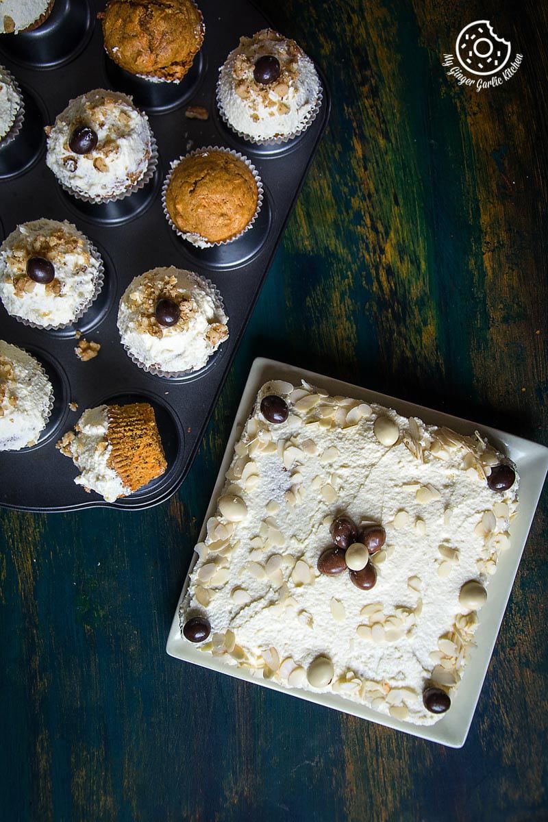 there are carrot cake cupcakes with lemon ricotta frosting in a muffin tin on a table