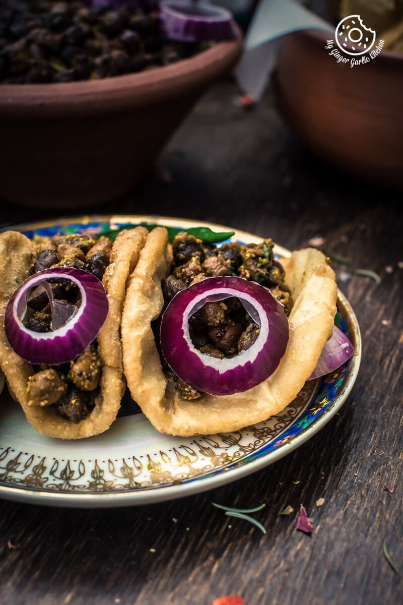 there are two puris with kala chana masala on a plate