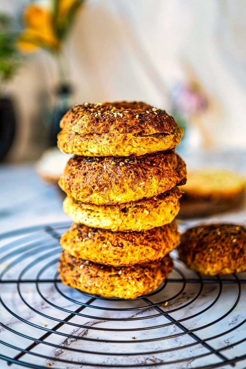 Stack of freshly baked 2 ingredient cottage cheese bagels with everything bagel seasoning cooling on a wire rack.