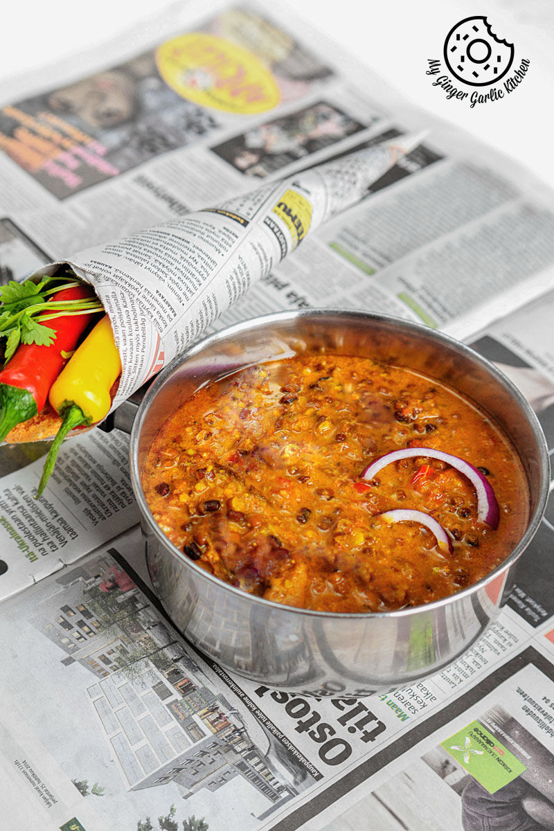 a bowl of dal bukhara on a newspaper