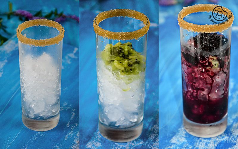 three glasses of different drinks with ice and garnish on a blue table