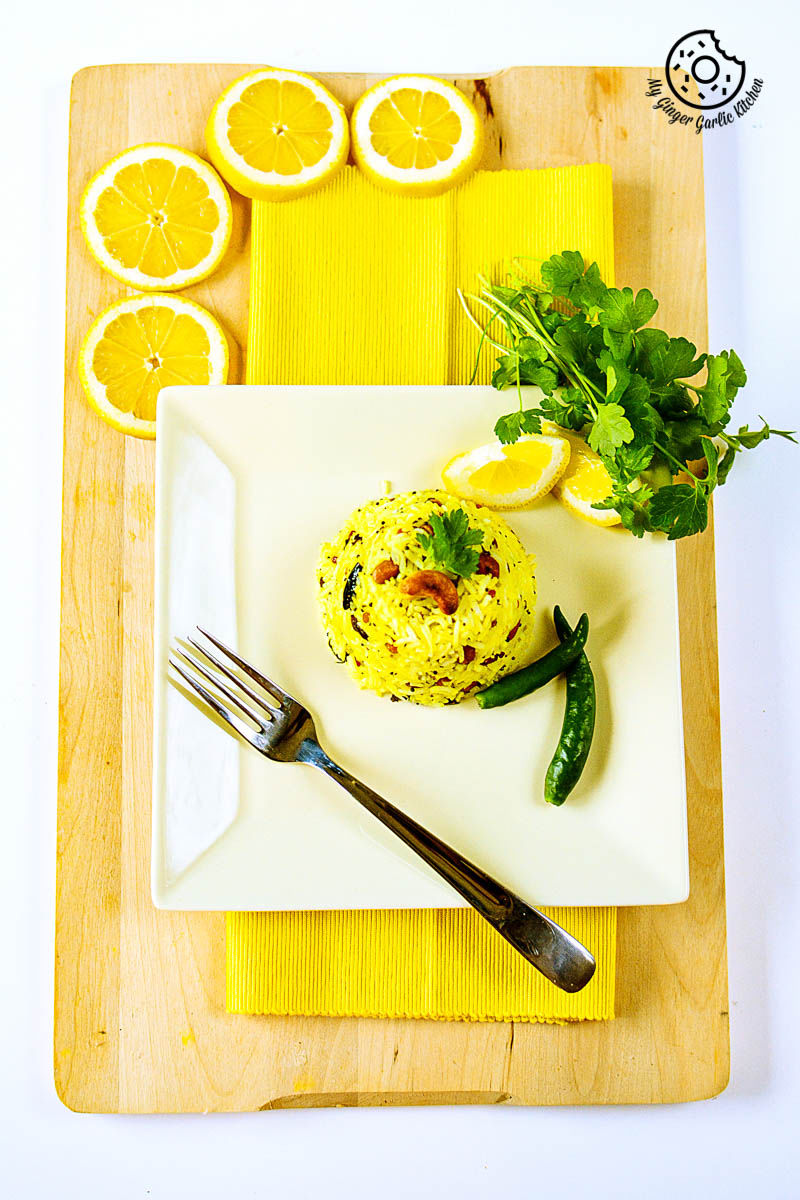 a plate with south indian lemon rice and a fork on it