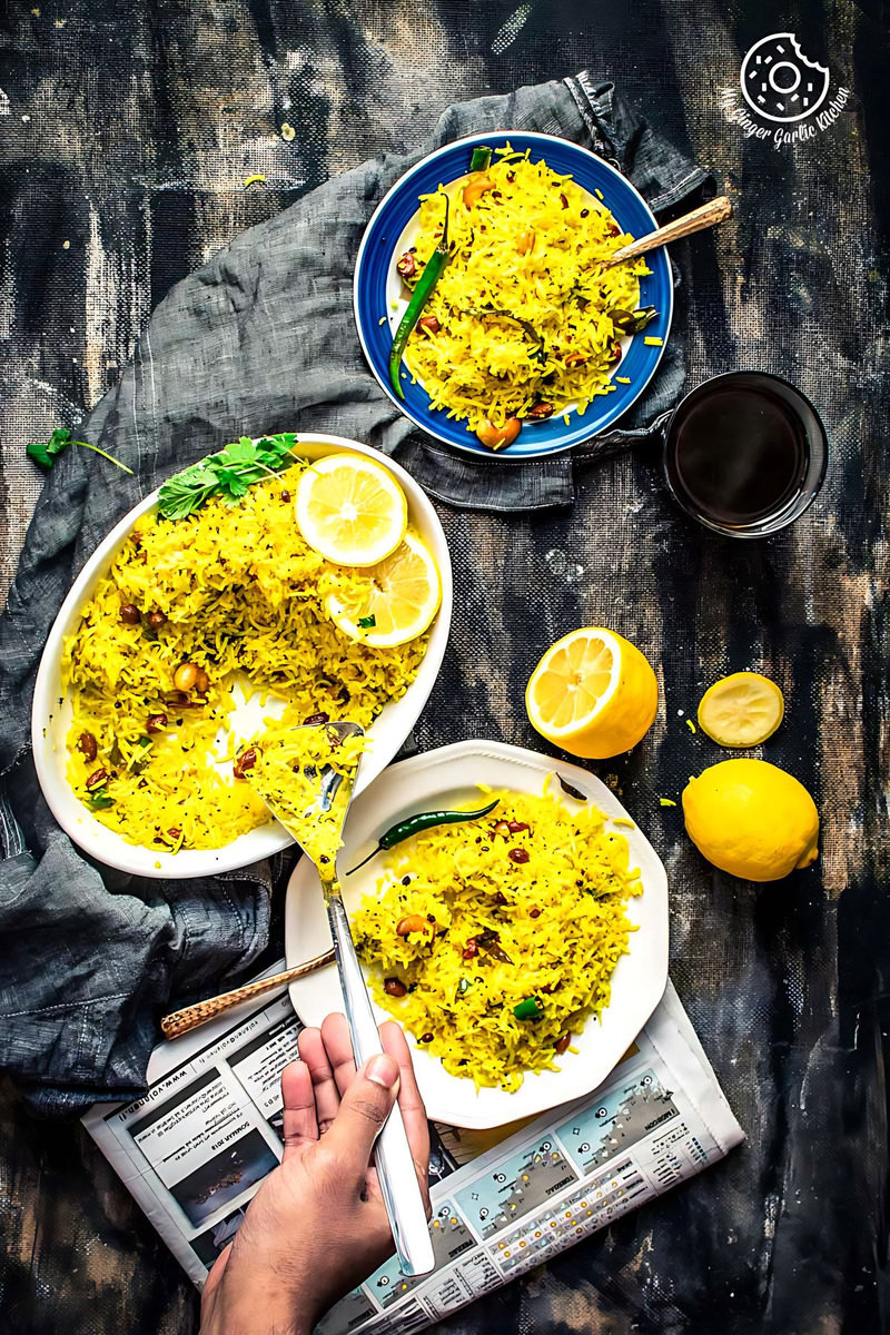a person holding a ladle and a plate of south indian lemon rice with two more lemon rice plates
