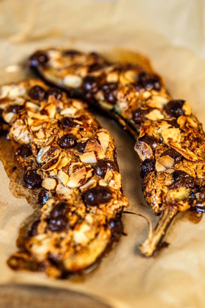 Warm and gooey Air Fryer Banana topped with creamy peanut butter, melted chocolate chips, and toasted sliced almonds, fresh from the air fryer.
