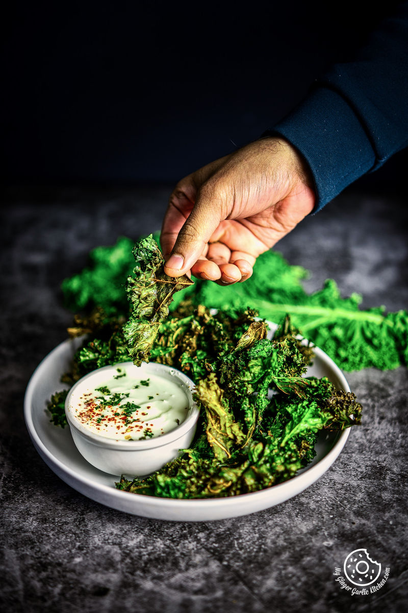 person holding air fryer kale chips