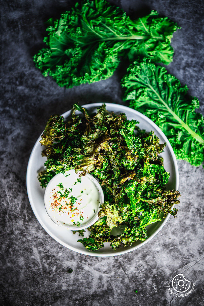 overhead image of air fryer kale chips served in white plate