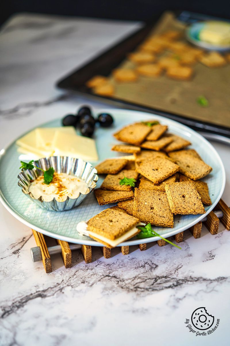 low carb almond flour crackers with vegan cheese, olives and dip