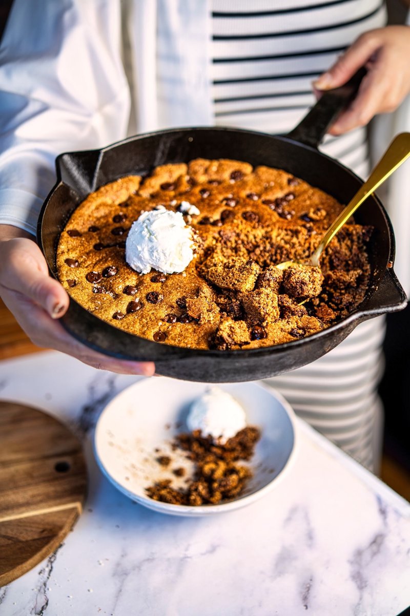Almond flour chocolate chip skillet cookie served warm with vanilla ice cream, crisp edges and a fudgy center.