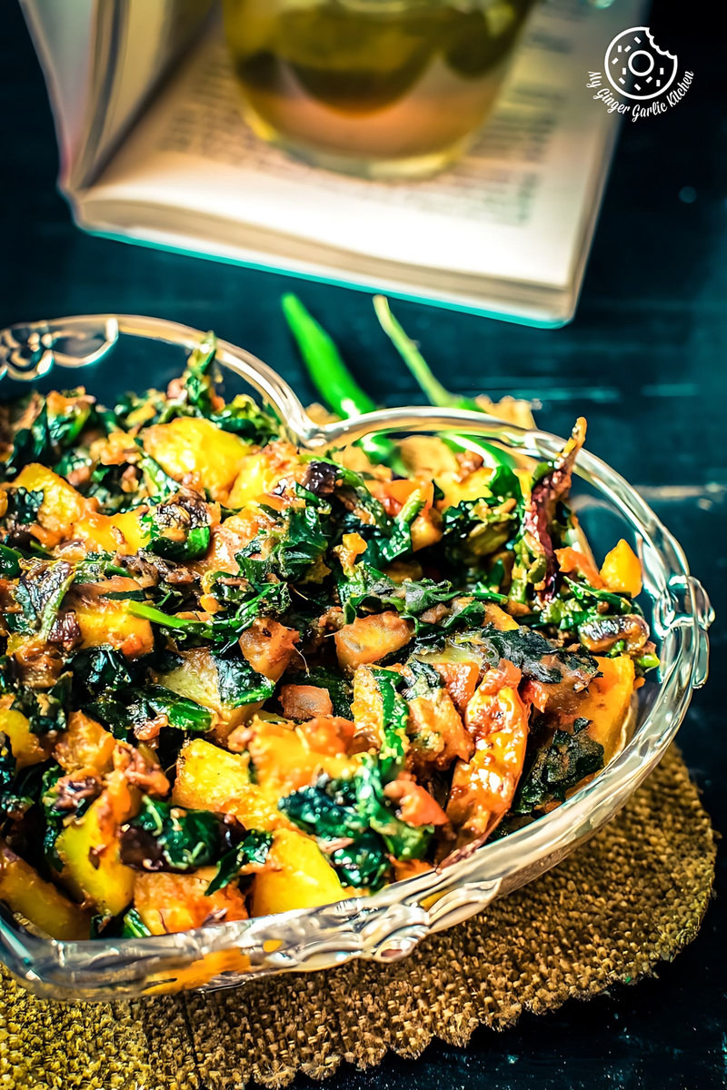 aloo palak served in a glass bowl on brown mat