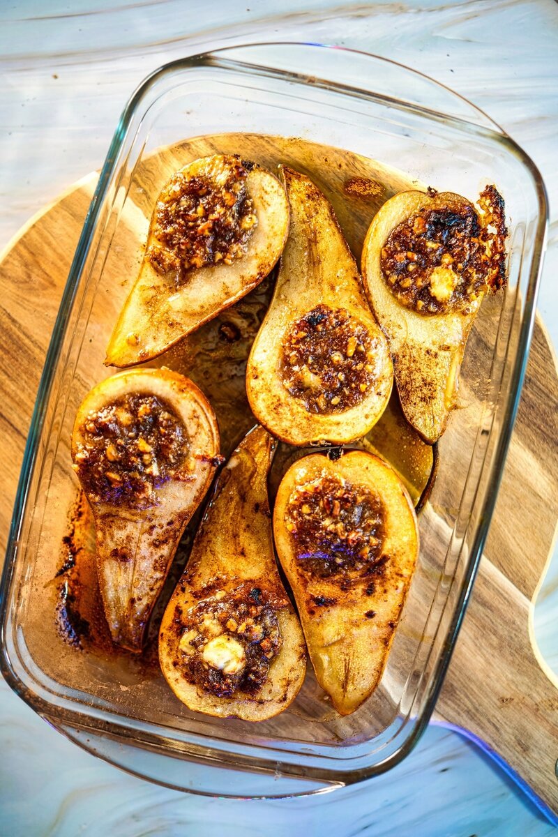 Top view of baked pears with goat cheese and walnuts baked until caramelized, simple vegetarian dessert recipe