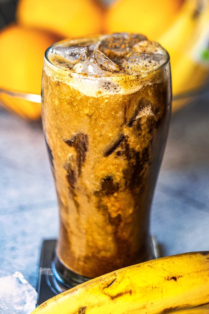 Homemade banana iced latte with cinnamon, ice, and fresh bananas