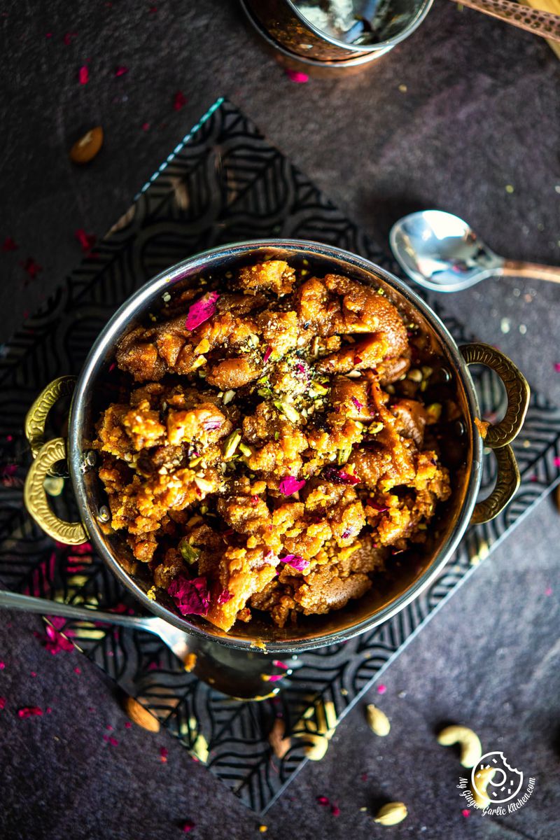 overhead shot of a besan halwa plate sitting on top of a glass plate