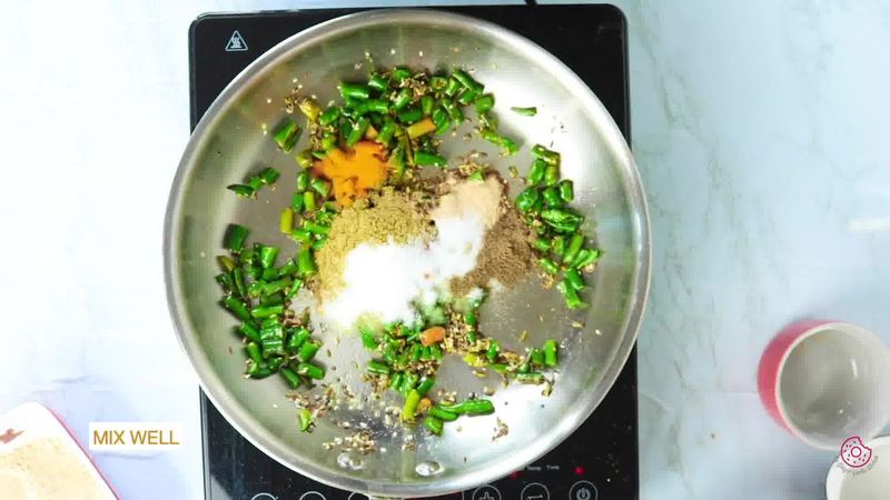 Image of the recipe cooking step-1-8 for Besan Mirchi Ke Tipore - Garm Flour Green Chili Stir-Fry