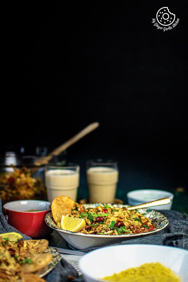 bhelpuri served in a plate and two tea glasses in the background