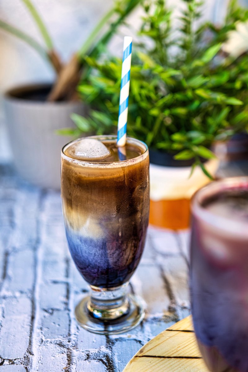 Blueberry iced oat latte with homemade blueberry syrup, creamy oat milk, espresso, and gorgeous layered colors