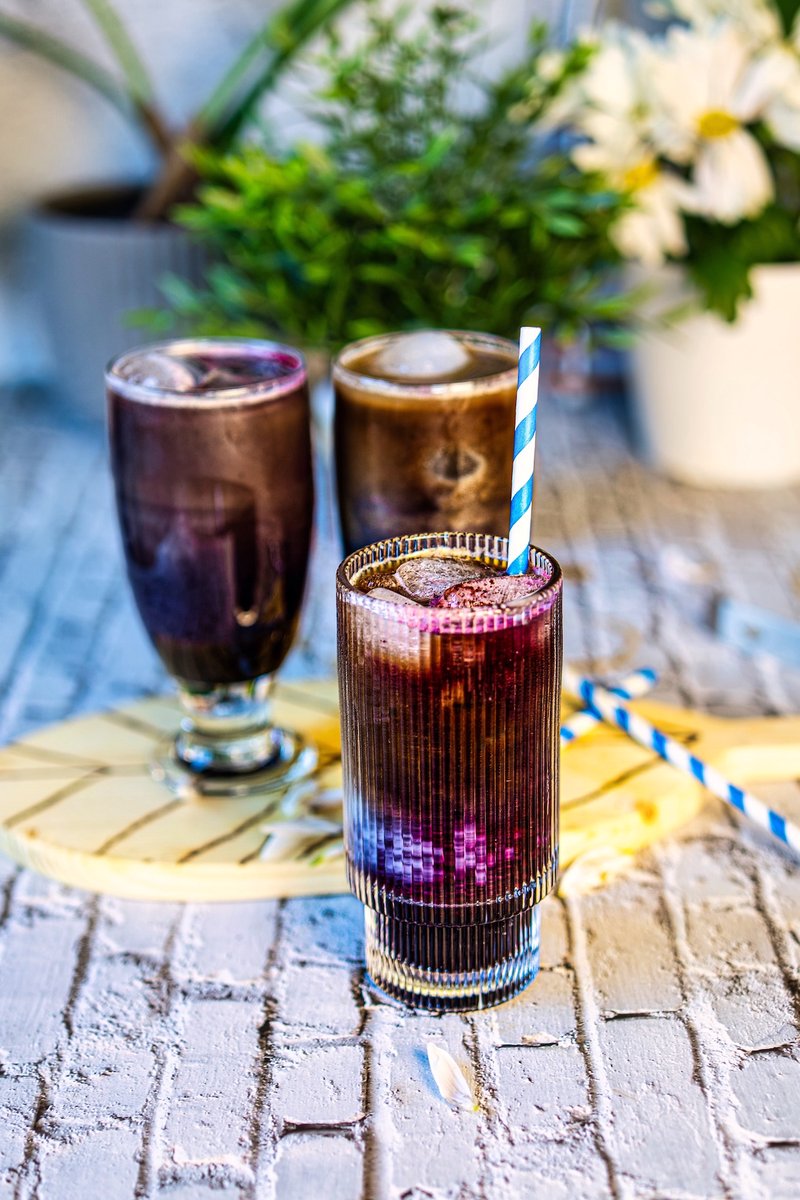 Blueberry iced latte with homemade blueberry syrup served over ice for a refreshing fruity coffee drink