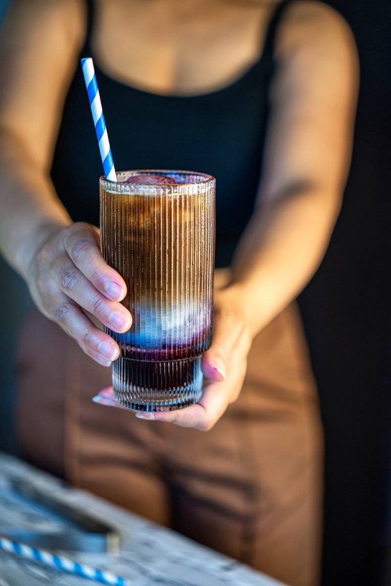 Blueberry oat latte with homemade blueberry syrup, espresso, and creamy oat milk served over ice