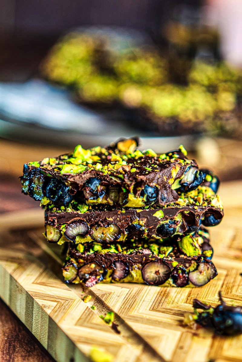Close-up of Blueberry Pistachio Chocolate Bark showing juicy blueberries, pistachio butter, dark chocolate, and crunchy roasted pistachios.