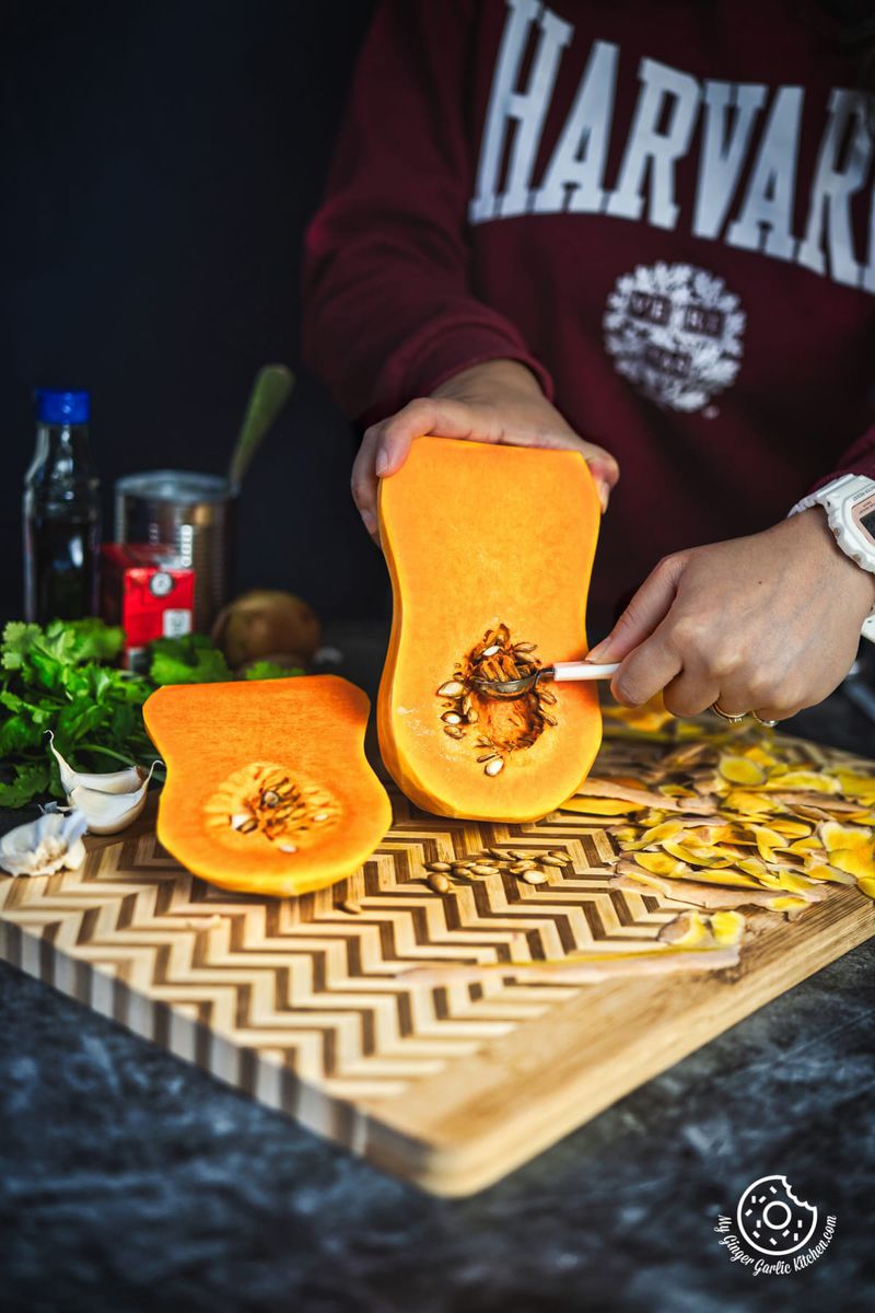 Person removing seeds from butternut squash