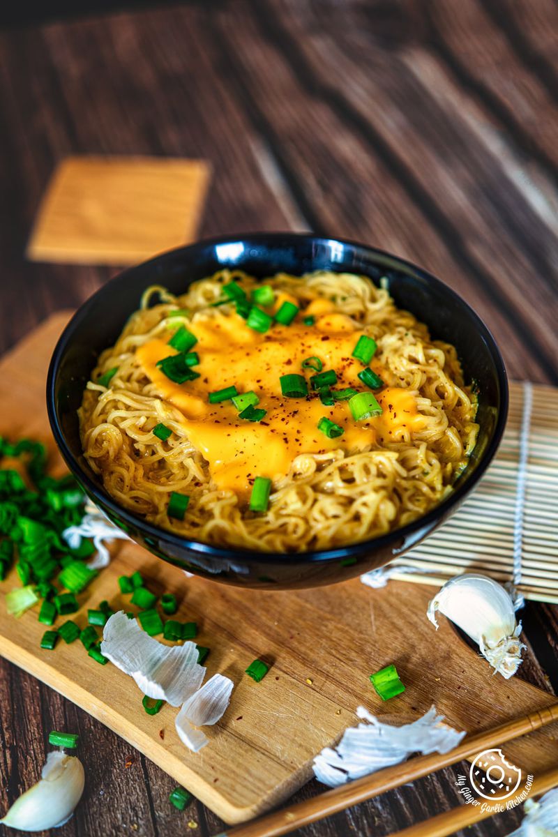 photo of a bowl of cheese ramen noodles with cheese and green onions
