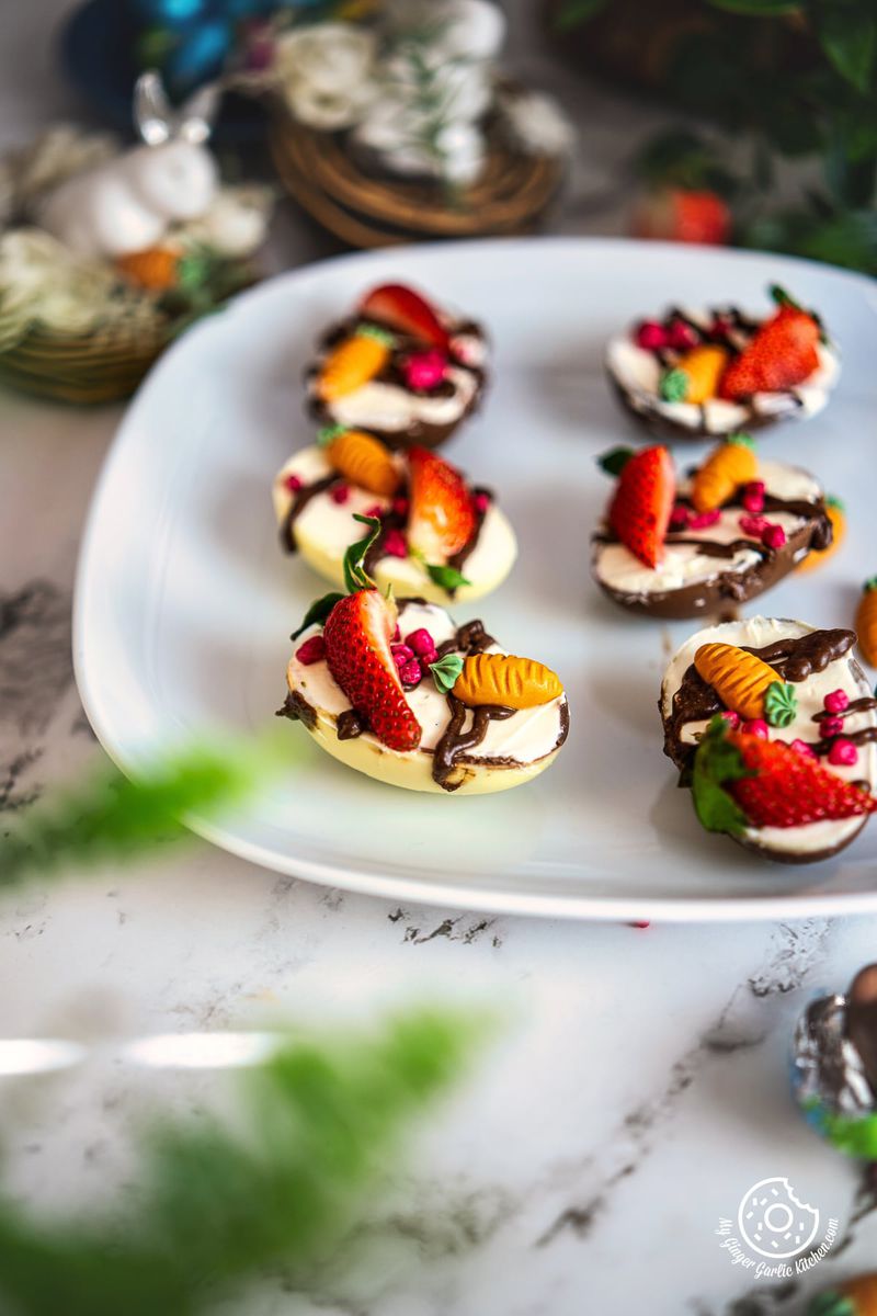 6 cheesecake filled easter eggs on a white plate