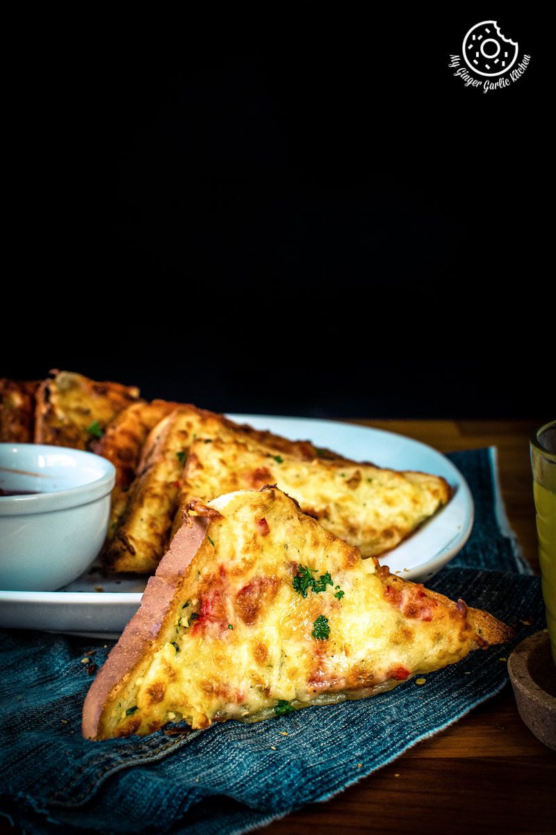 chilli cheese toast shot on a dark background