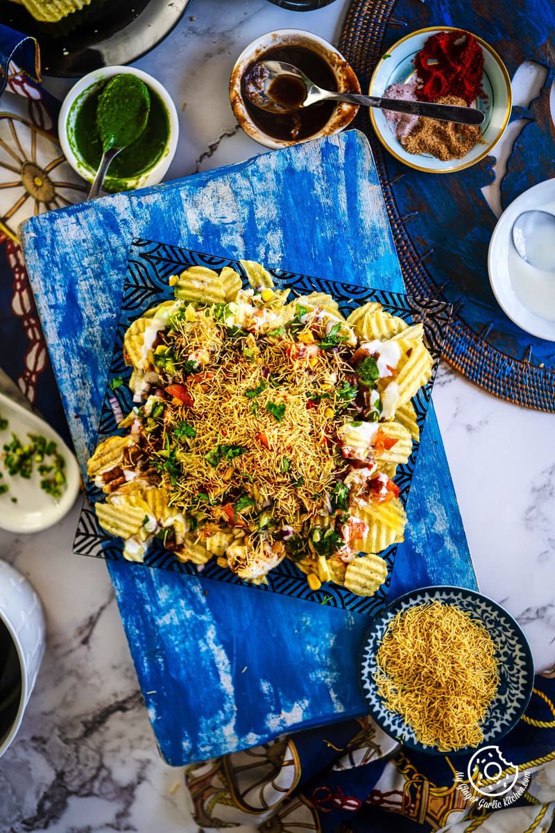 overhead shot of chips chaat along with chutenys and sev on the side