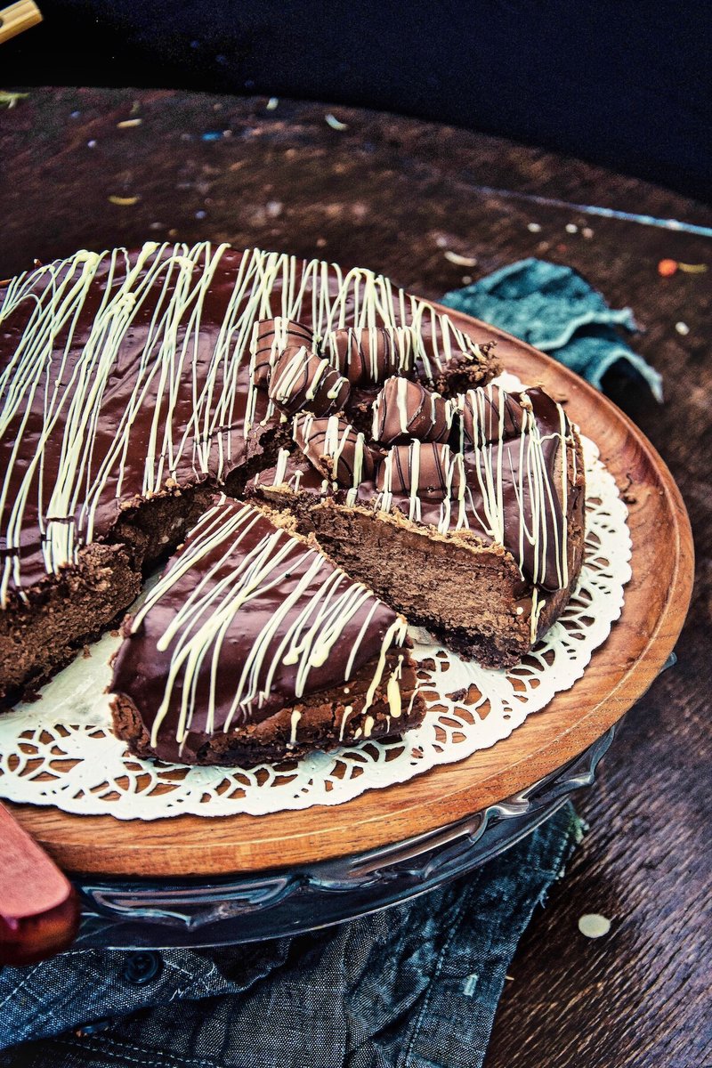 Homemade Chocolate Cheesecake with smooth chocolate ganache and sliced serving pieces