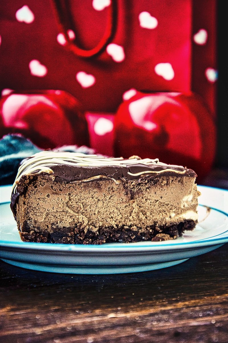 Slice of creamy Chocolate Cheesecake with chocolate cookie crust and chocolate ganache topping