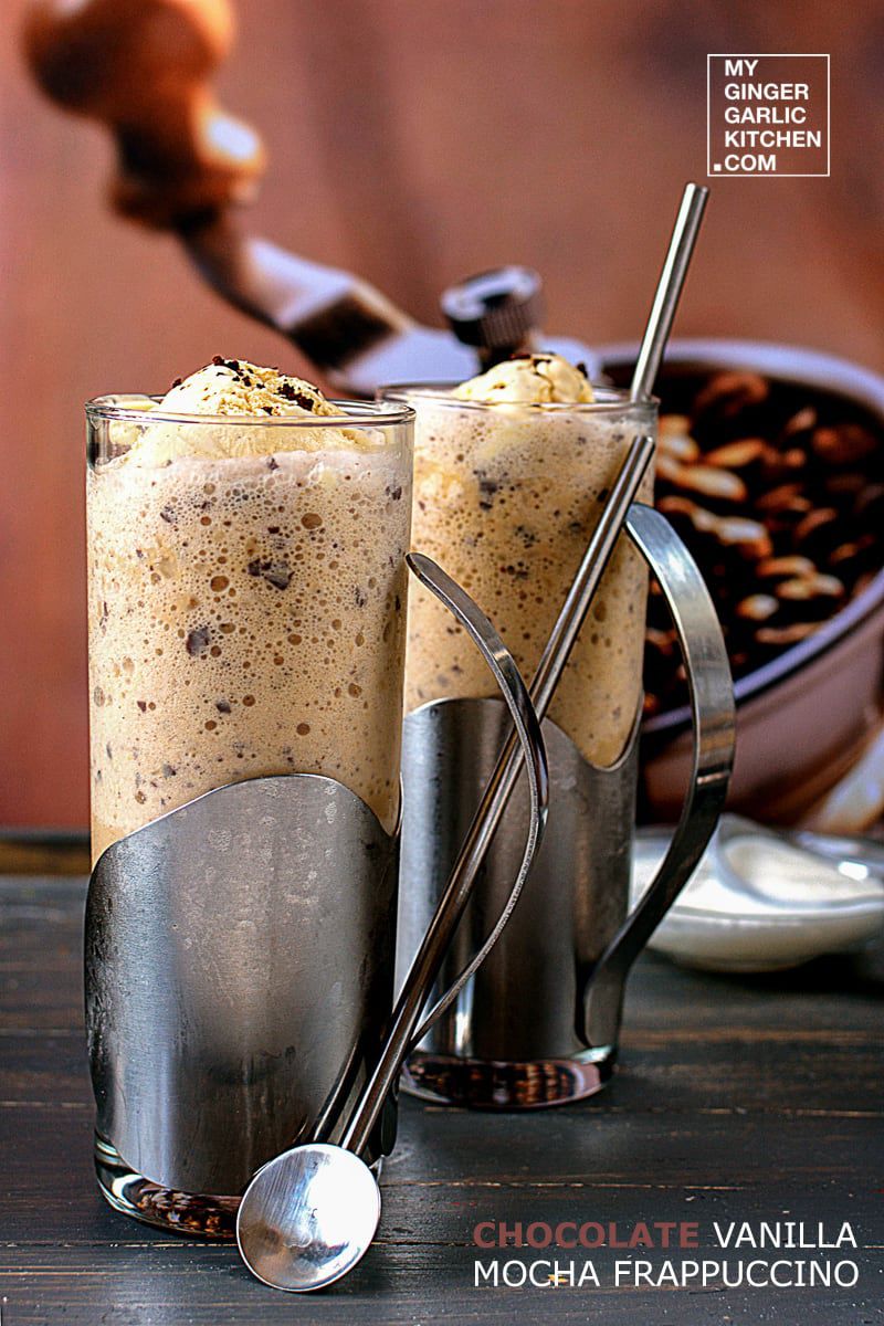 two glasses of chocolate mocha vanilla frappuccino with a spoon and spoon rest on a table