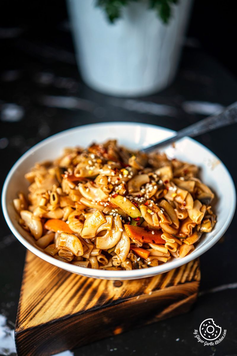 photo of a bowl of Chow-Mein Style Macaroni on a wooden board