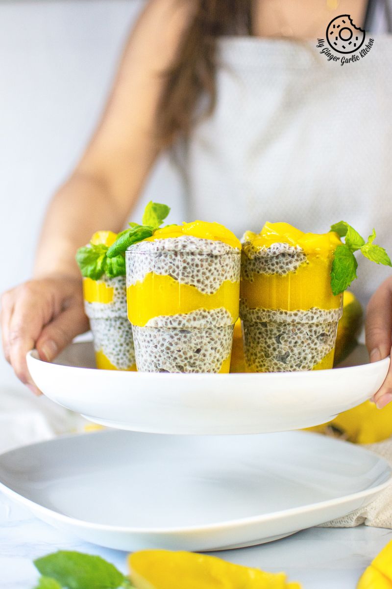 coconut mango chia pudding topped with mangoes