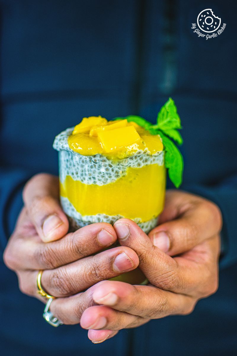 coconut mango chia pudding topped with mangoes