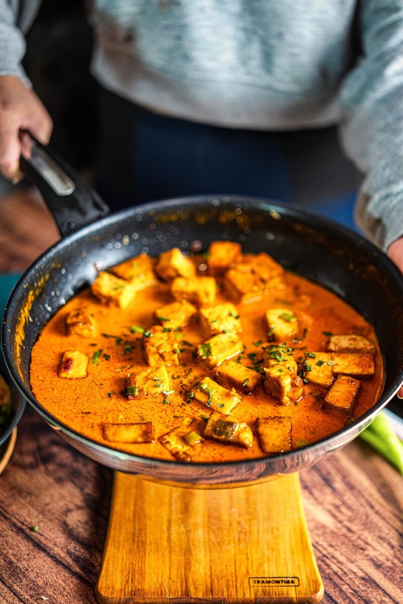 Homemade coconut lime tofu curry in skillet, creamy dairy-free curry with golden tofu pieces ready to serve