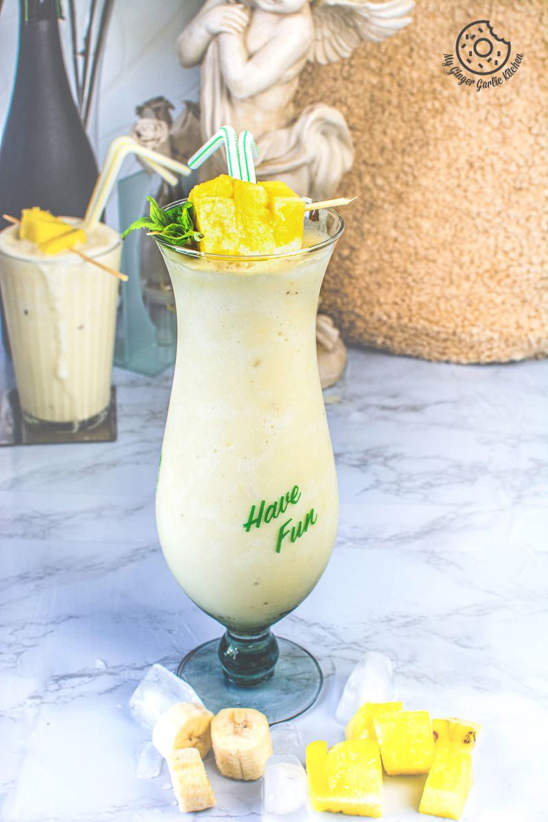 pineapple coconut smoothie with pineapple chunks and yellow straws