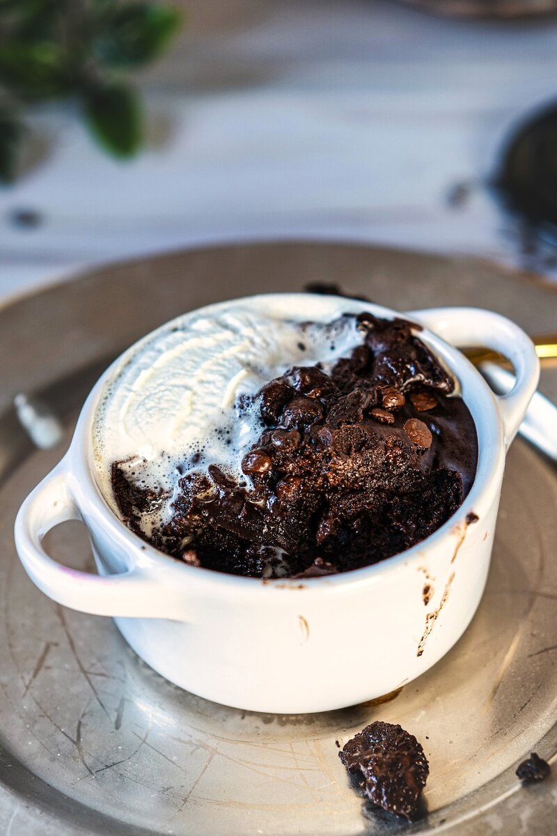 Gooey cottage cheese chocolate mug cake served with vanilla ice cream in a white ramekin, easy microwave chocolate dessert