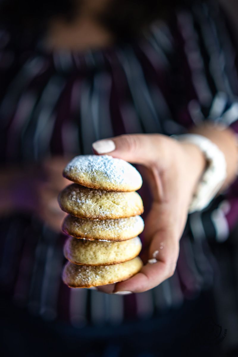 A female holding cream cheese cookies stack in hands