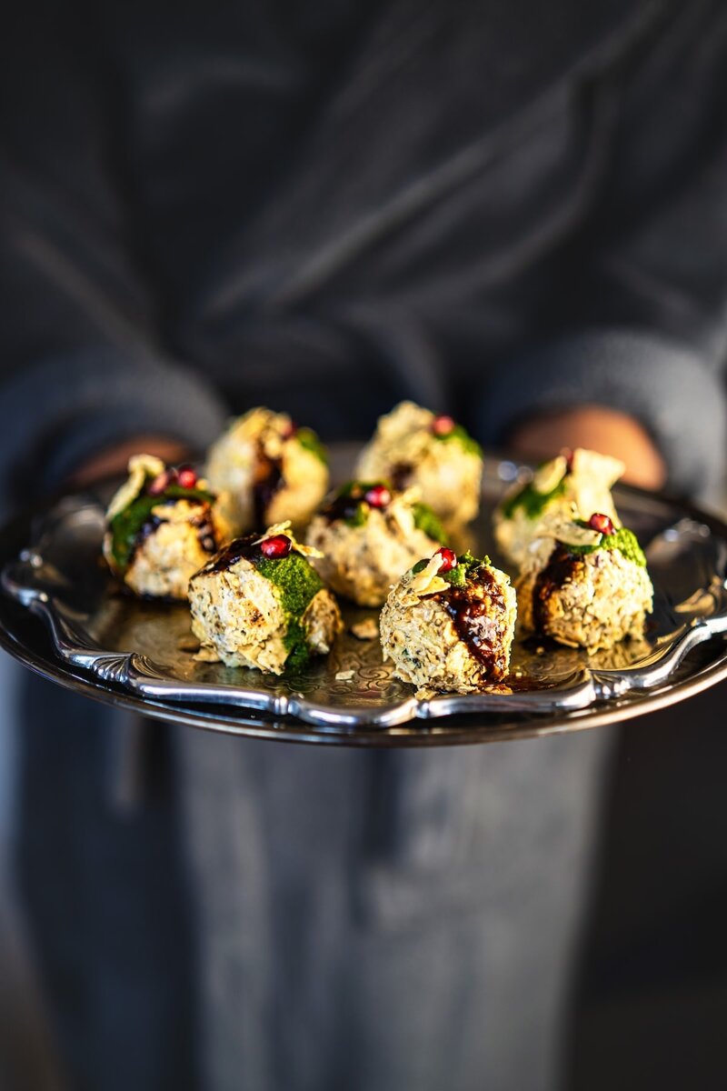 Cream Cheese Corn Chaat Balls arranged on a silver platter. A festive Indian fusion snack combining creamy cheese with tangy chutneys and pomegranate arils.