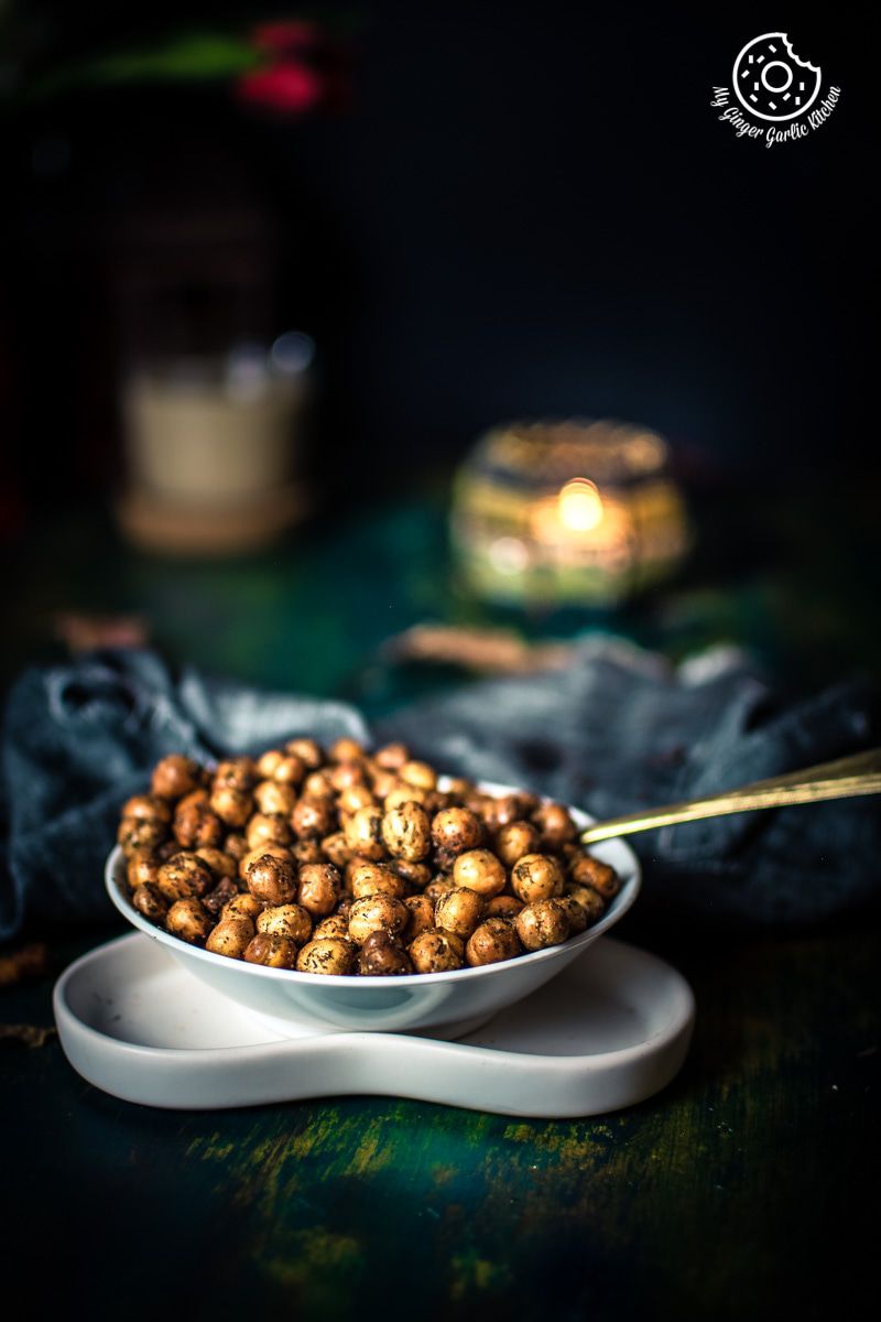 there is a bowl of crispy chana on a plate with a spoon