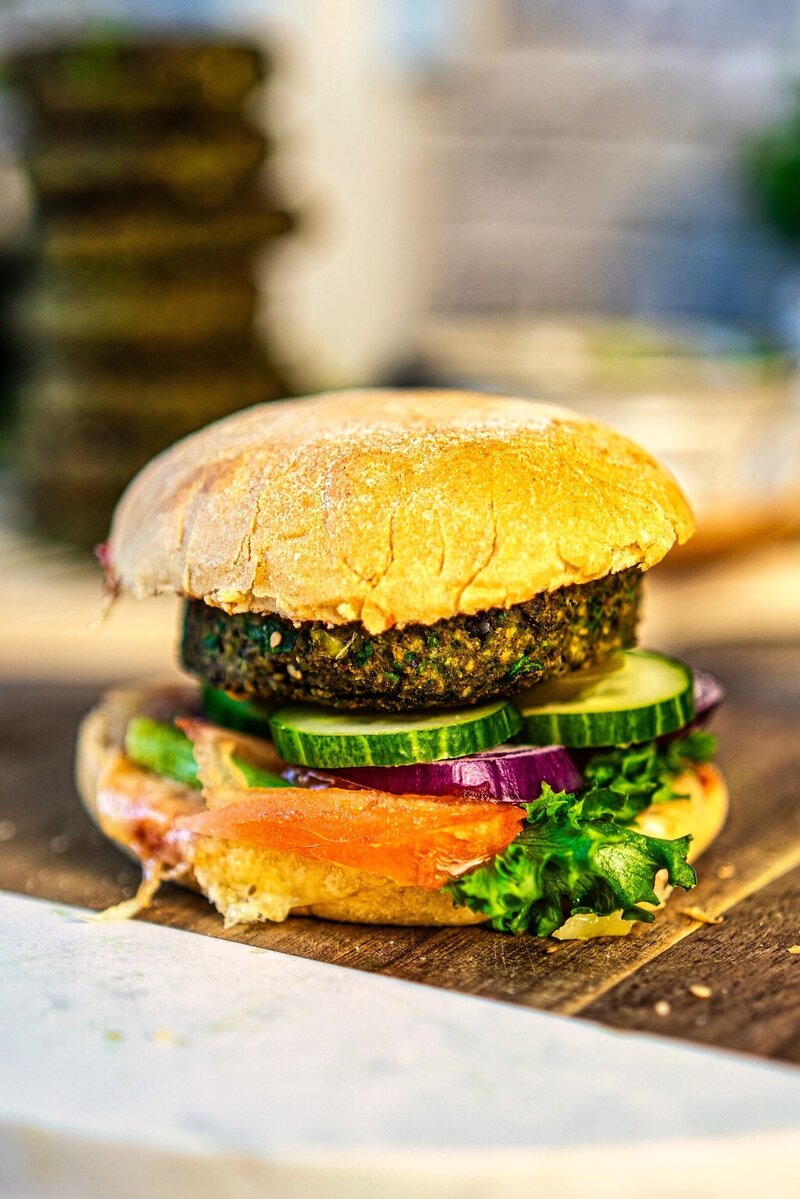 Black bean veggie burger made with crispy black bean veggie patties lettuce tomato and avocado dip