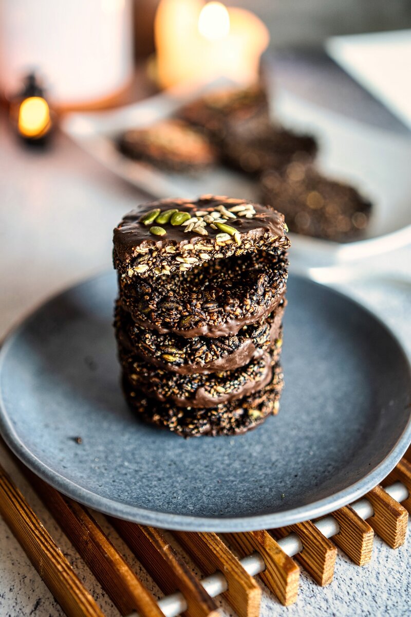 Stacked crunchy seed chocolate bites made with pumpkin seeds, sunflower seeds, chia seeds, and dark chocolate, vegan and gluten-free