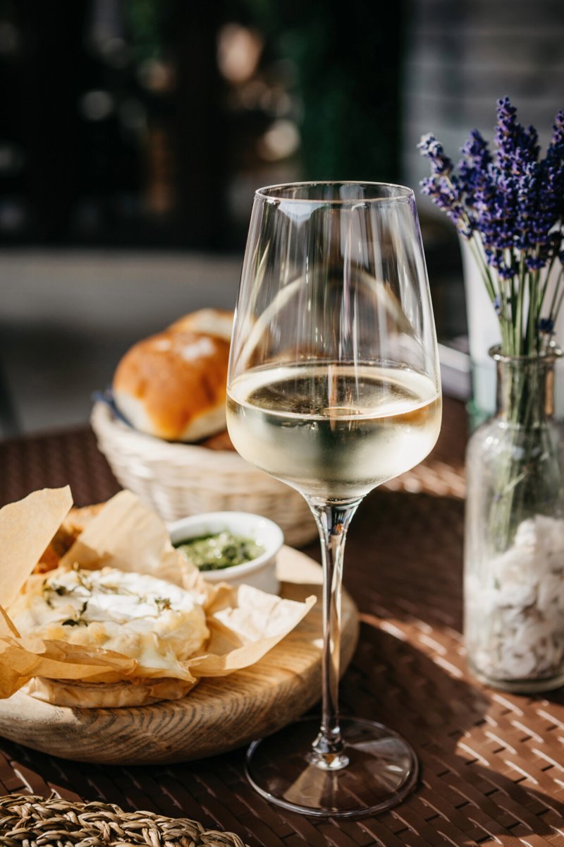 Glass of chilled white wine served with appetizers for a spicy fusion dinner