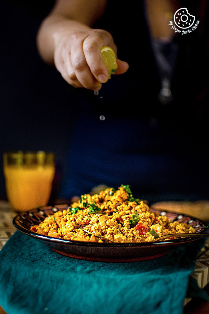 egg bhurji served in a brown plate along with ornage juice