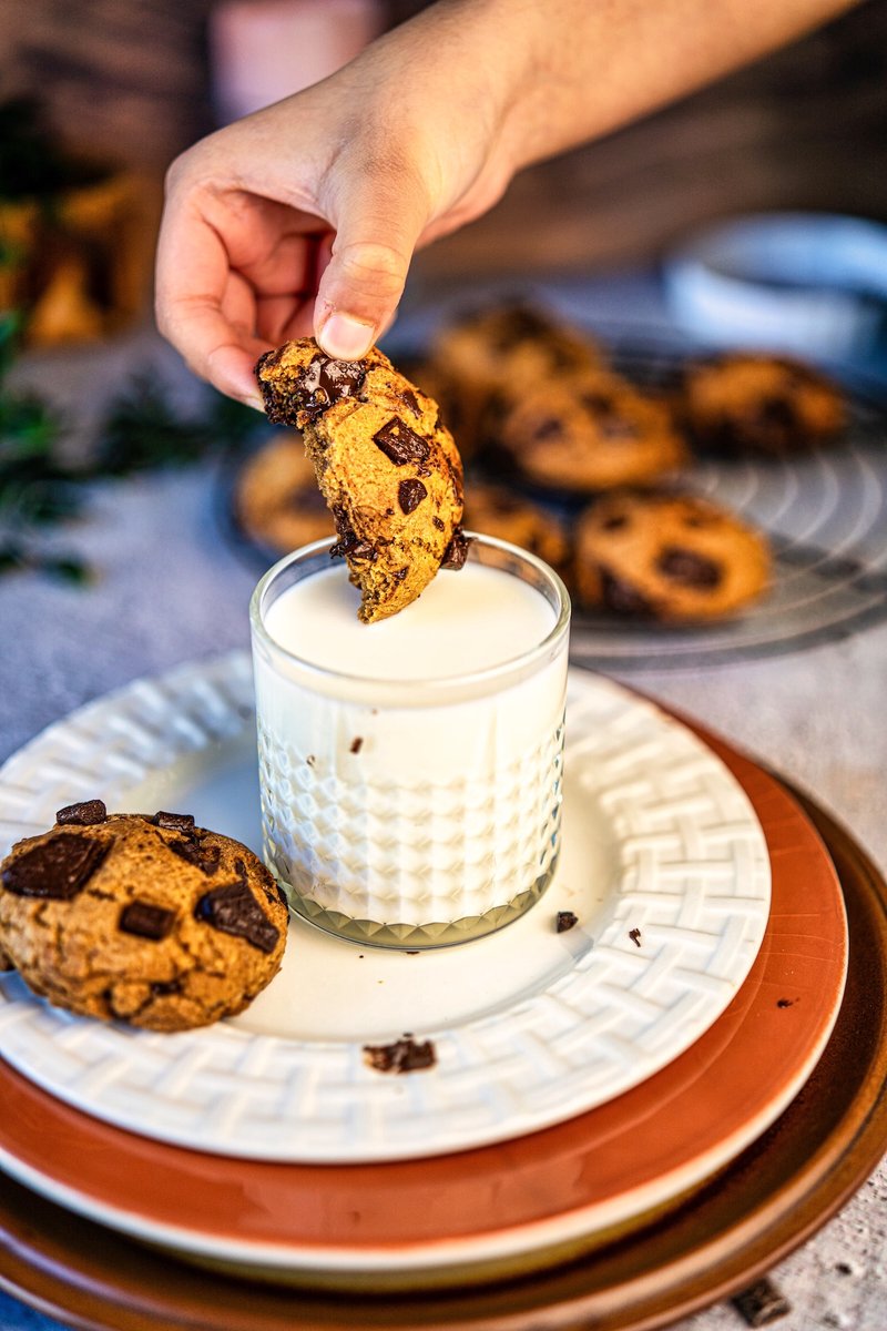 Eggless brown butter chocolate chip cookie dipped in milk with gooey melted chocolate chunks, soft chewy bakery-style homemade cookie without eggs