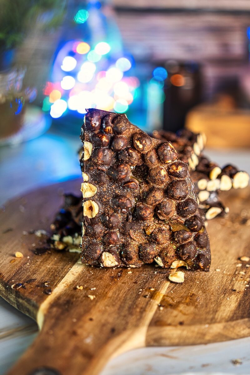 Close-up of espresso hazelnut dark chocolate bark slice, vegan dark chocolate hazelnut bark with caramel drizzle