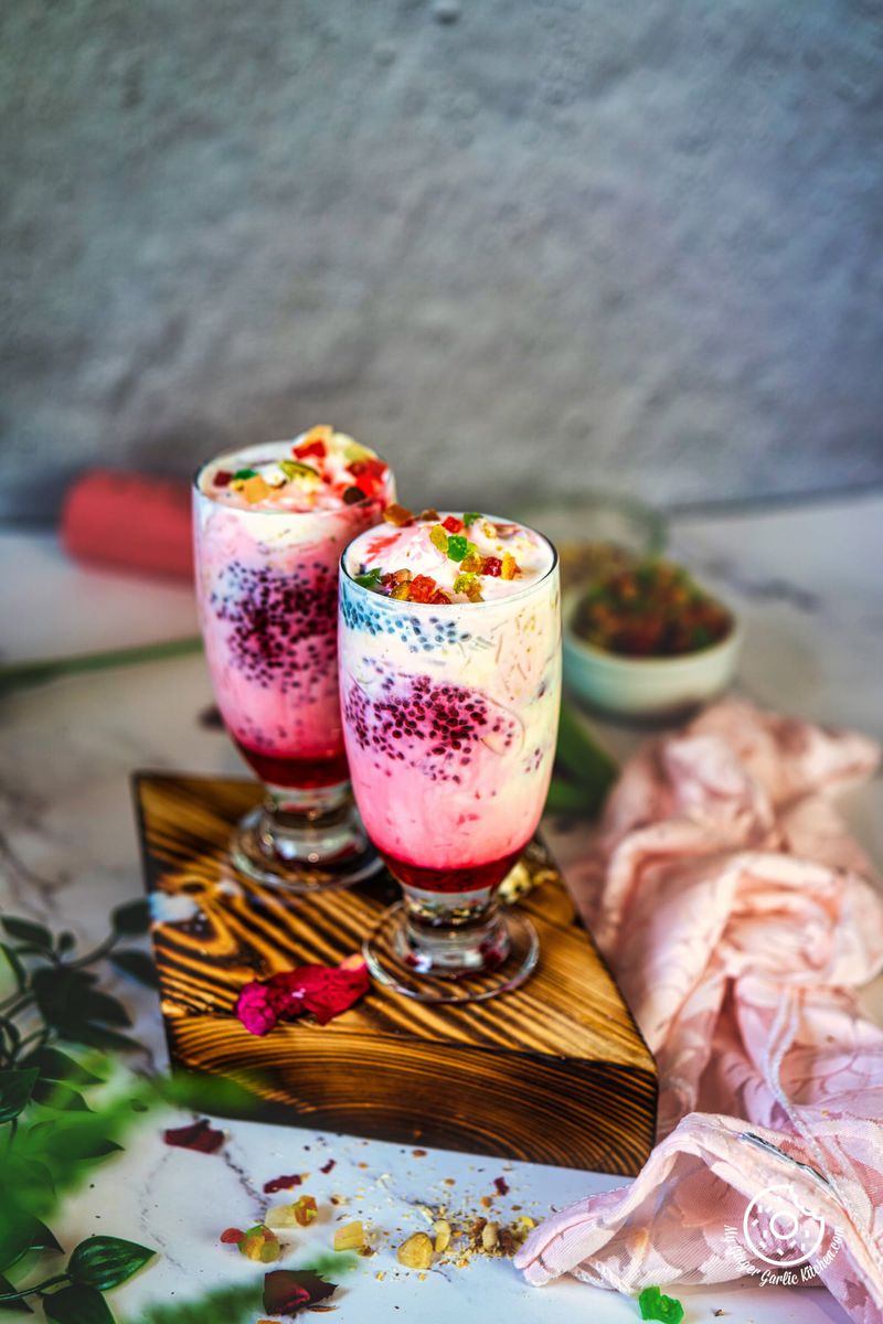 photo of are two glasses falooda dessert on a wooden tray