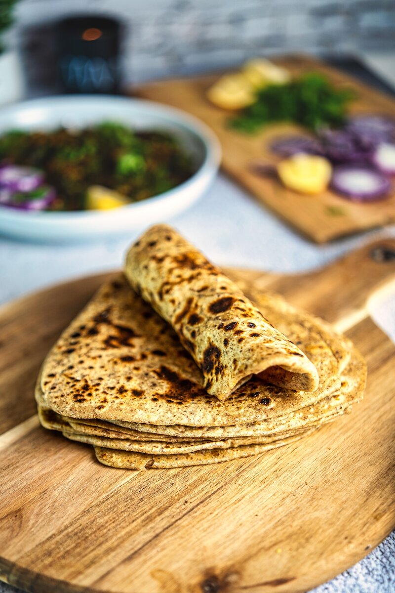 Soft and flaky flaxseed paratha rolled and stacked, vegan whole wheat flatbread for wraps and meals
